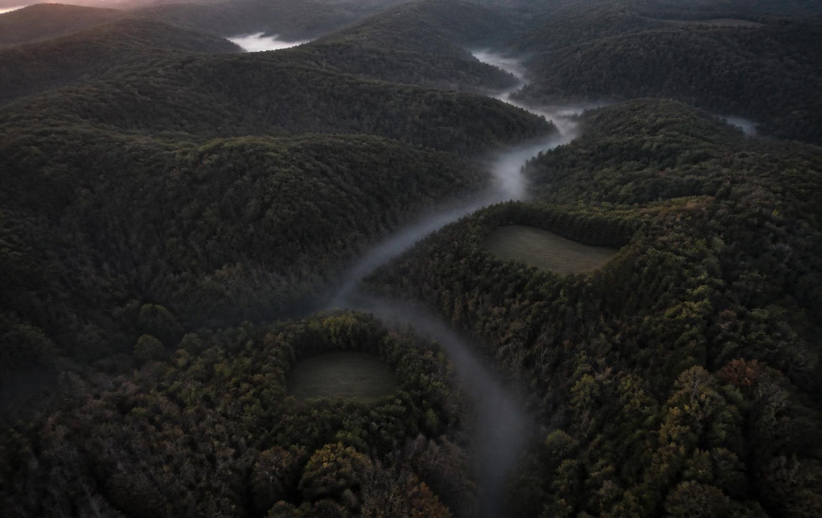 Aerial view of timbered hunting property with ridges and a creek drainage